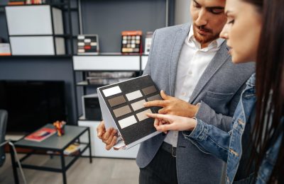 salesman-shows-color-swatches-lady-customer-new-kitchen-furniture_93675-134887